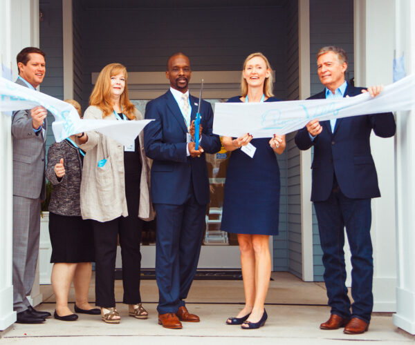 Business team at a ribbon-cutting ceremony.