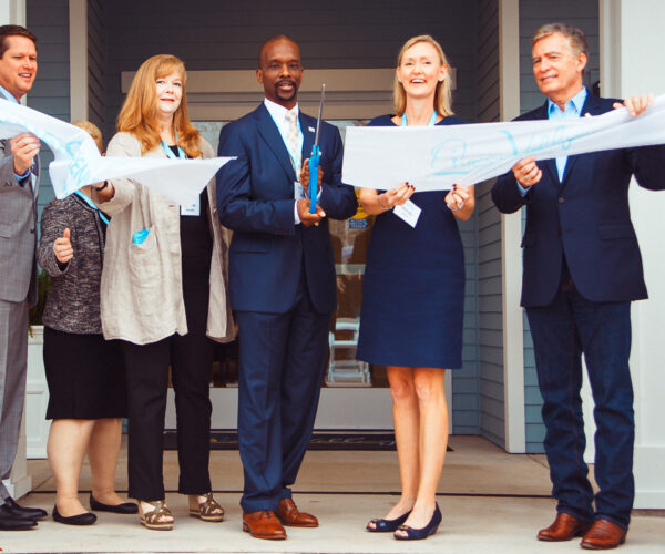Business team at a ribbon-cutting ceremony.