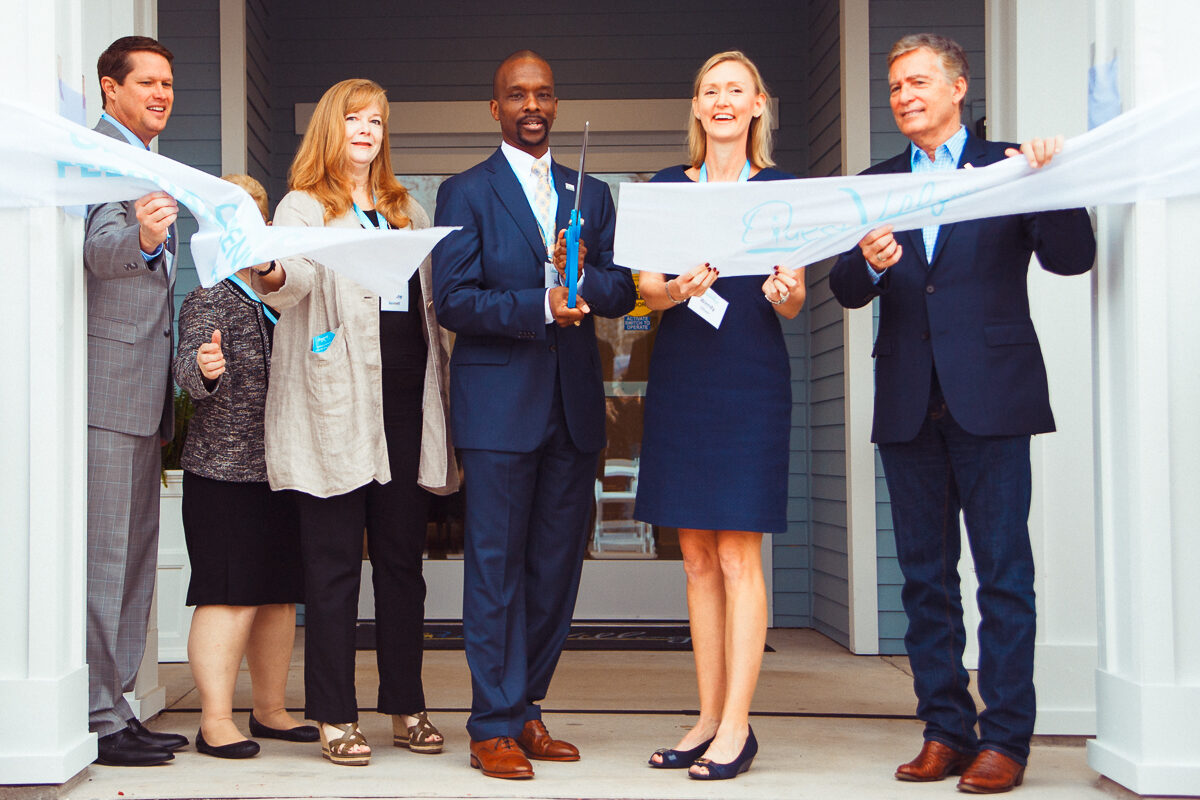 Business team at a ribbon-cutting ceremony.