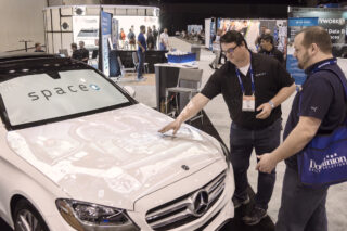 Attendees view a projected car display at the Digital Dealer Conference & Expo at the Orange County Convention Center.