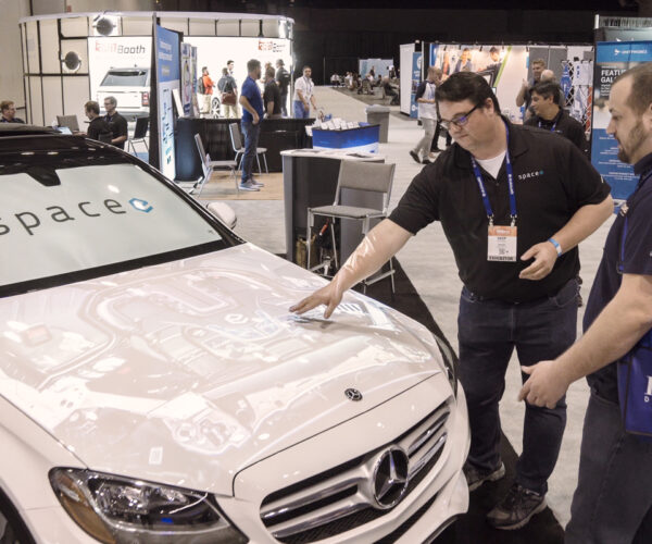 Attendees view a projected car display at the digital dealer conference & expo at the orange county convention center.