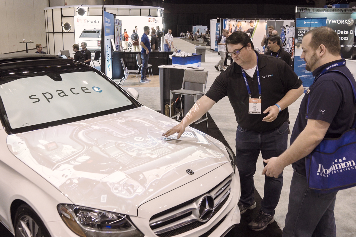 Attendees view a projected car display at the Digital Dealer Conference & Expo at the Orange County Convention Center.