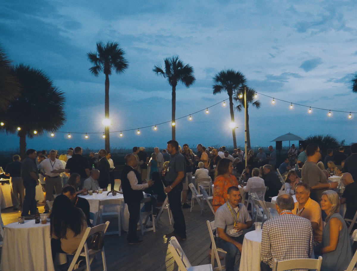 Outdoor evening party with guests and string lights