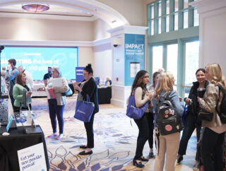 Attendees networking in a conference lobby.