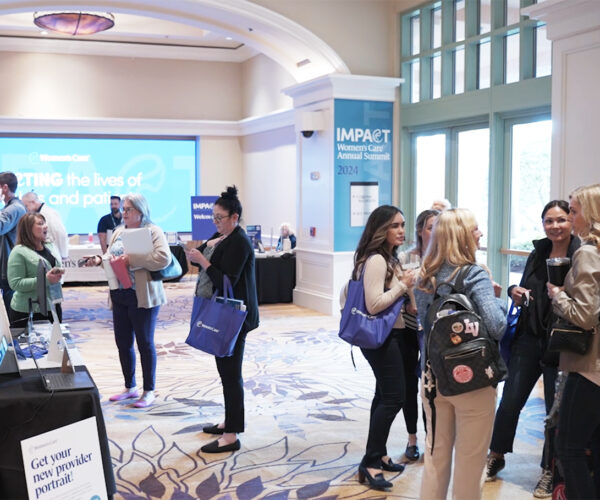 Networking event attendees engaging in conference lobby.