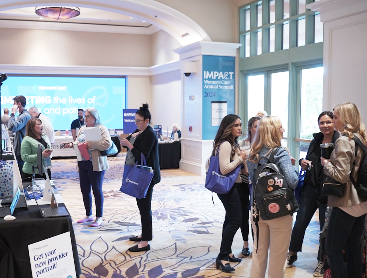 Networking event attendees engaging in conference lobby.