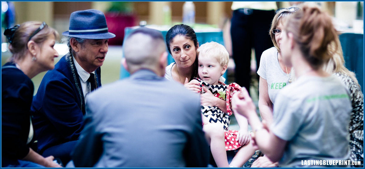 A diverse group of people engaged in conversation at caribe royale orlando, fostering collaboration and connection.