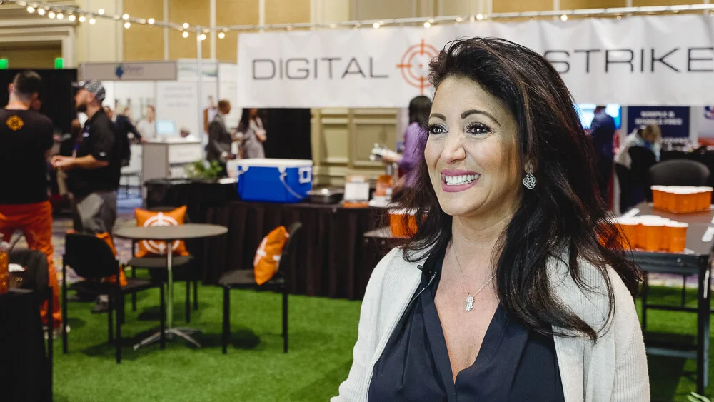 Woman smiling at digital strike event booth