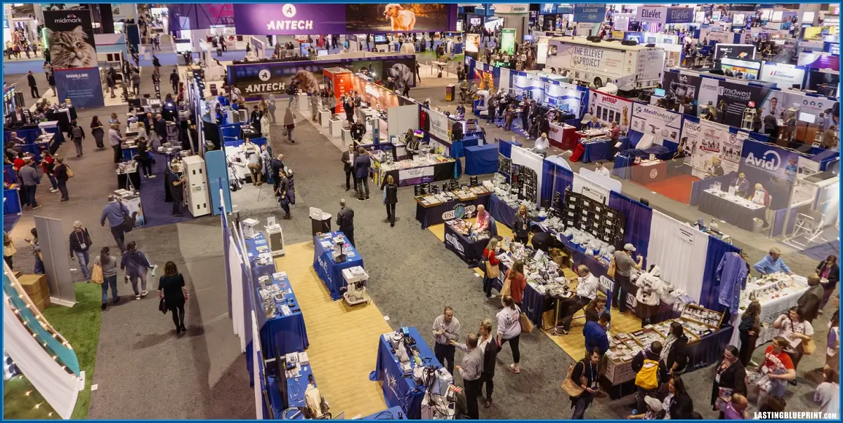 A crowded convention hall featuring numerous booths and exhibits related to technology and innovation. Attendees walk and interact with various displays.