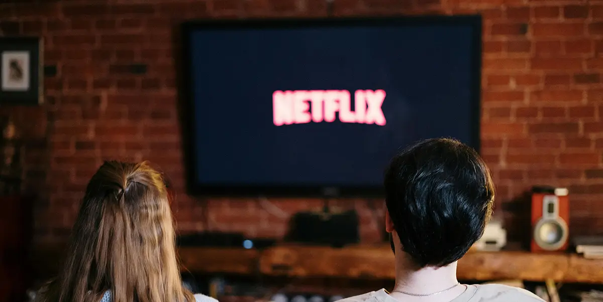 Two people watching netflix on tv at home