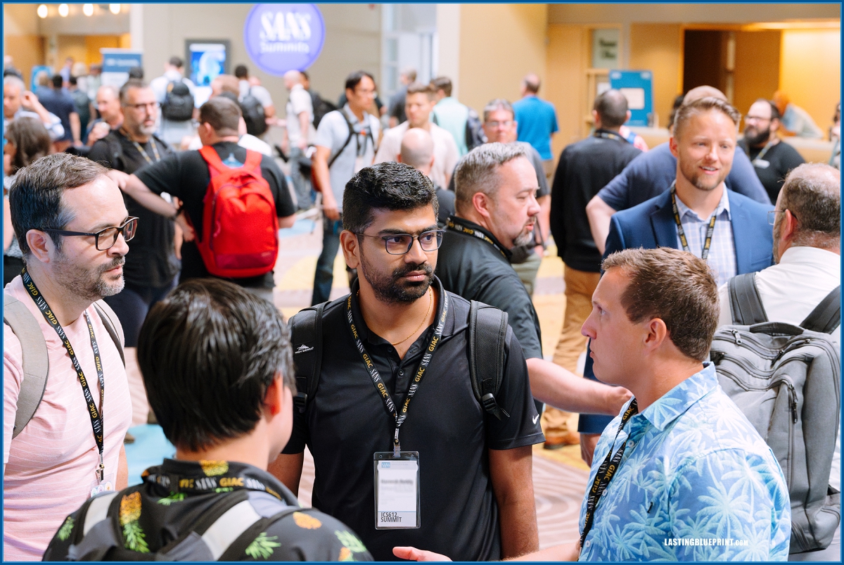 At disney's contemporary resort, conference attendees with badges and backpacks engage in lively conversations.