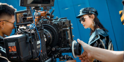 Cinema camera filming a woman during a branded video shoot.