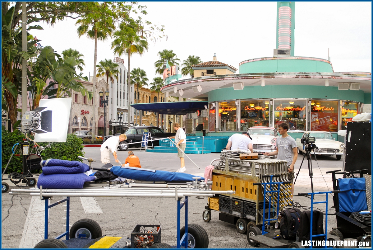 Behind the scenes photo of a film crew setting up equipment at universal studios orlando.