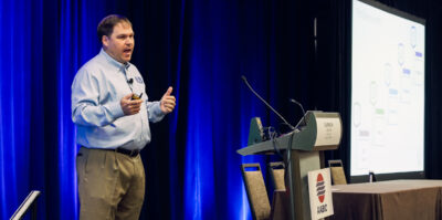 Speaker presenting during a professional association annual meeting.