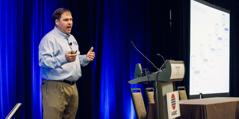Speaker presenting during a professional association annual meeting.