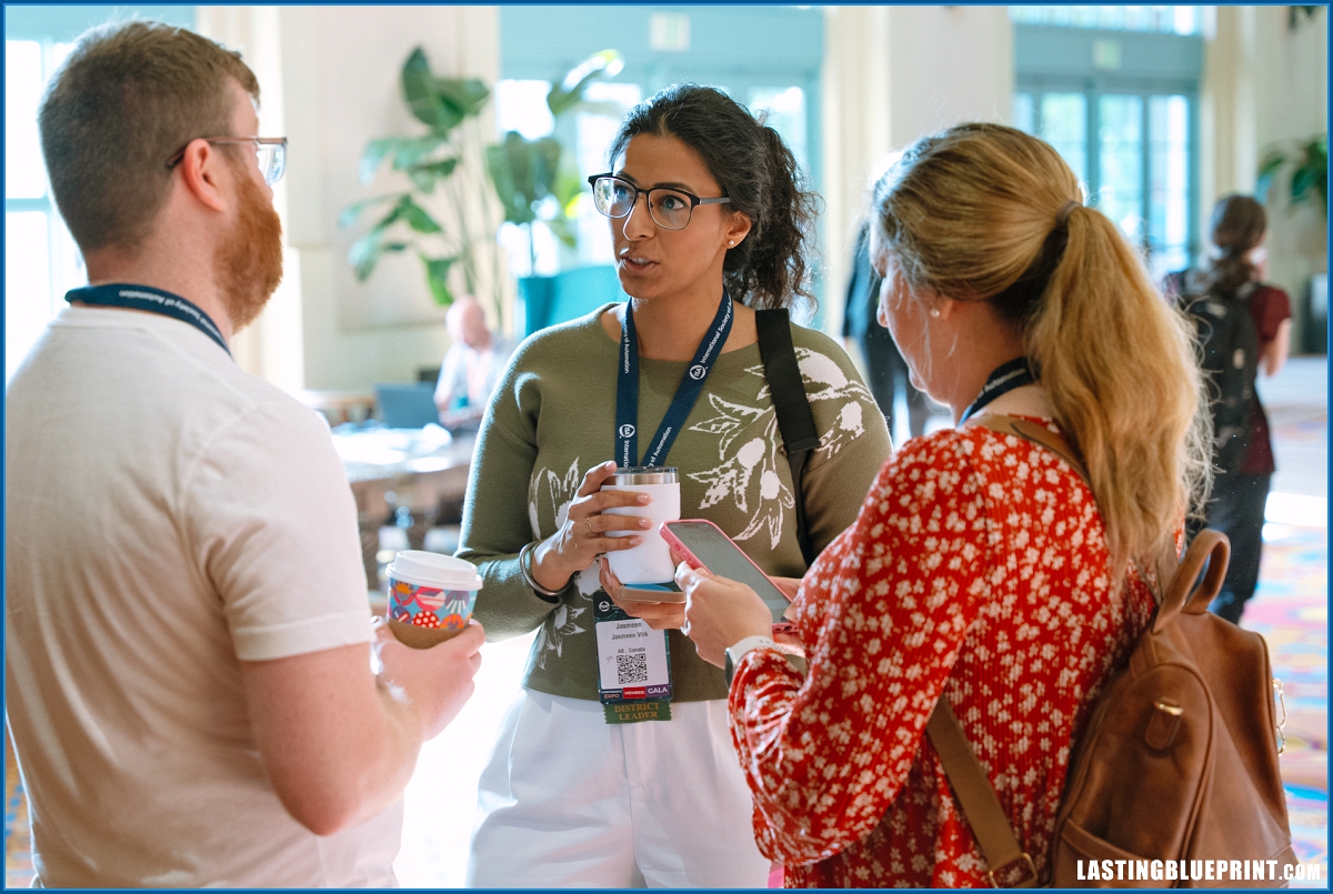 Attendees talking in the lobby during a conference at disney’s coronado springs resort in orlando.