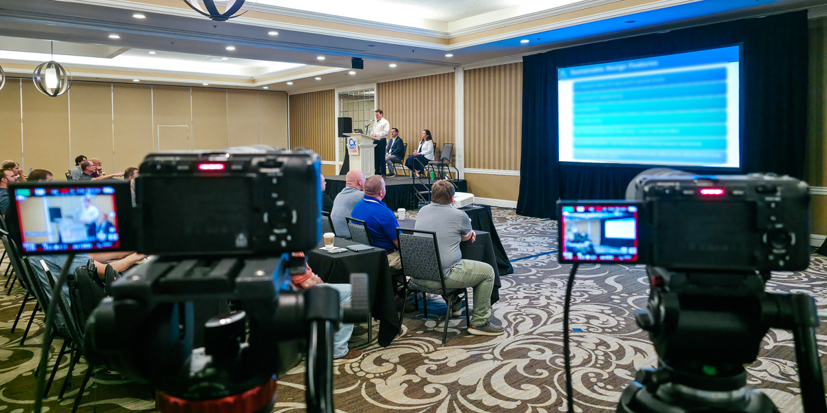 Two cameras filming a conference session at le méridien charlotte.