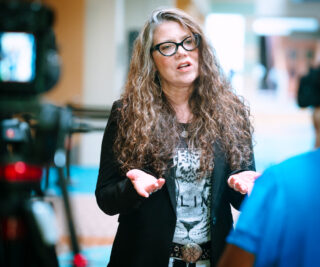 Woman speaking during an attendee testimonial interview at an industrial cybersecurity conference.