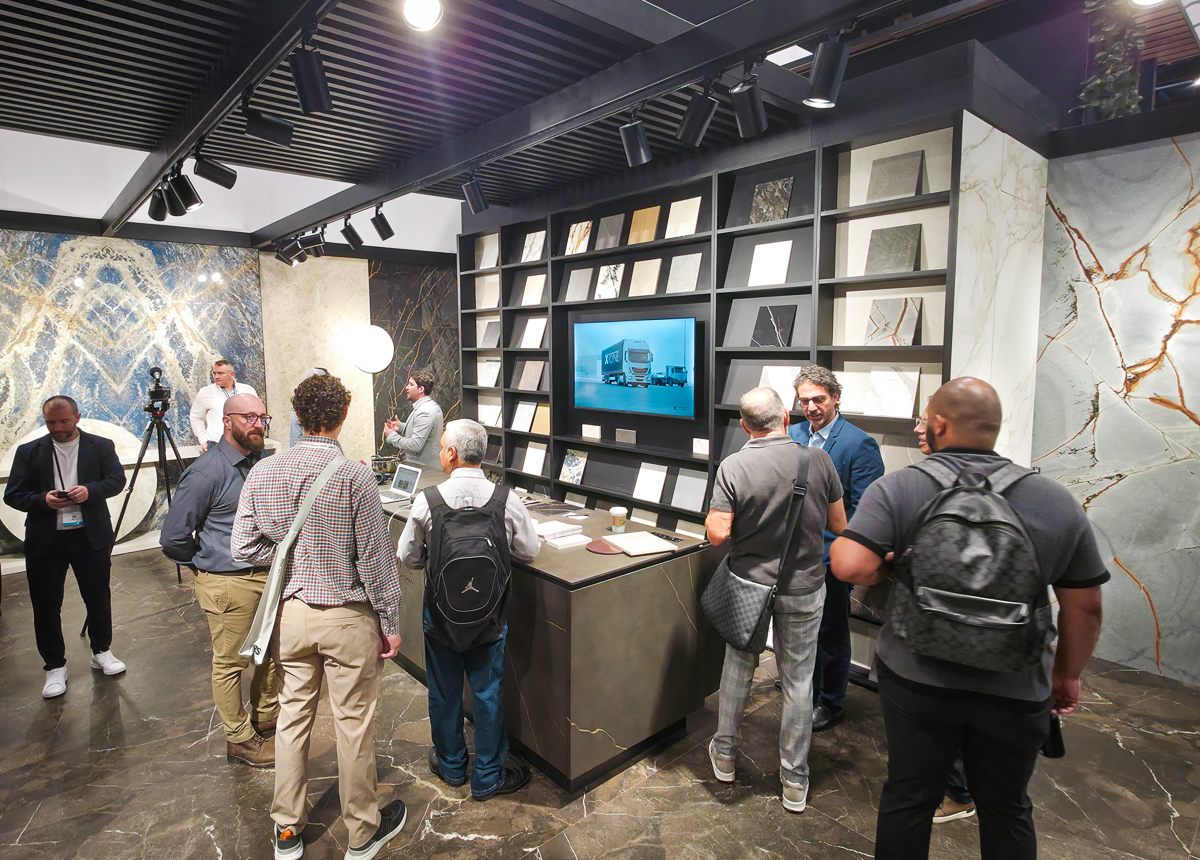Attendees interacting with a booth display at kbis trade show at the orange county convention center in orlando