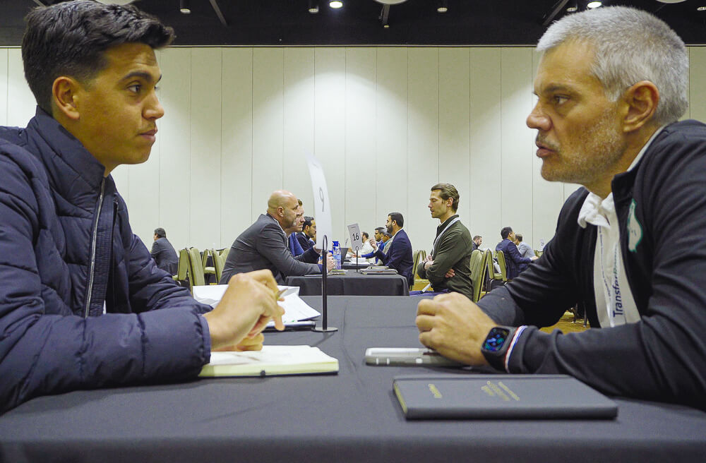 Attendees in a one-on-one meeting at the transferroom summit americas at jw marriott orlando