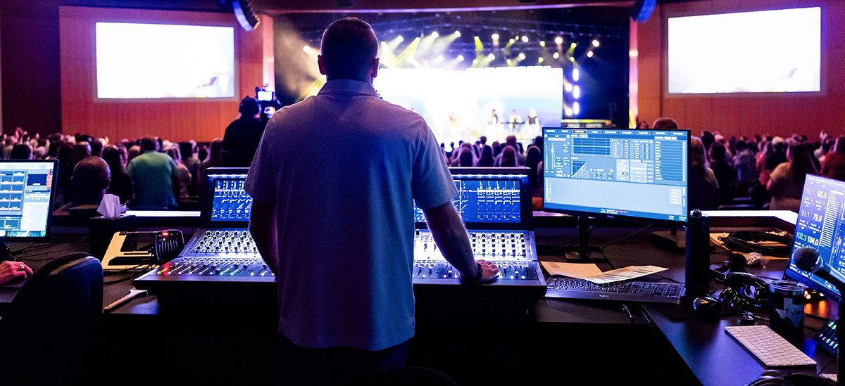 Av technician operating a production control booth during an orlando conference
