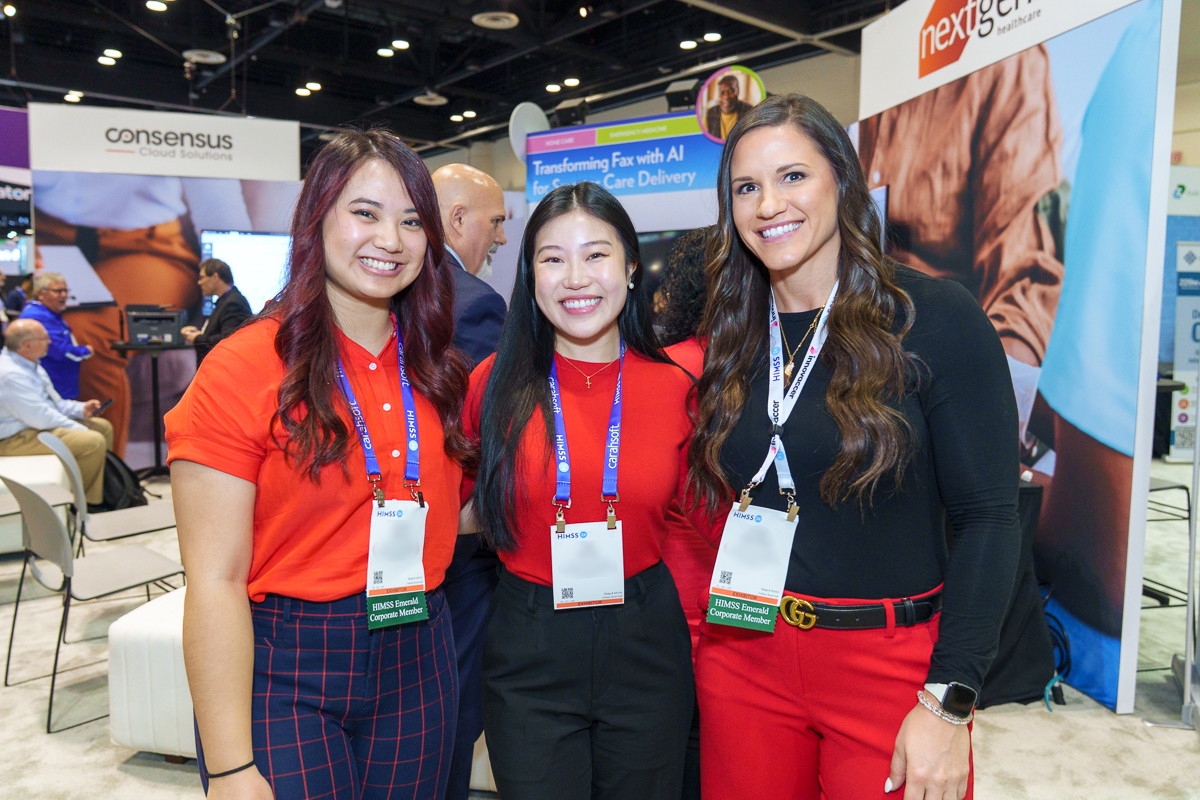 Exhibitor team posing at a trade show booth in the orange county convention center