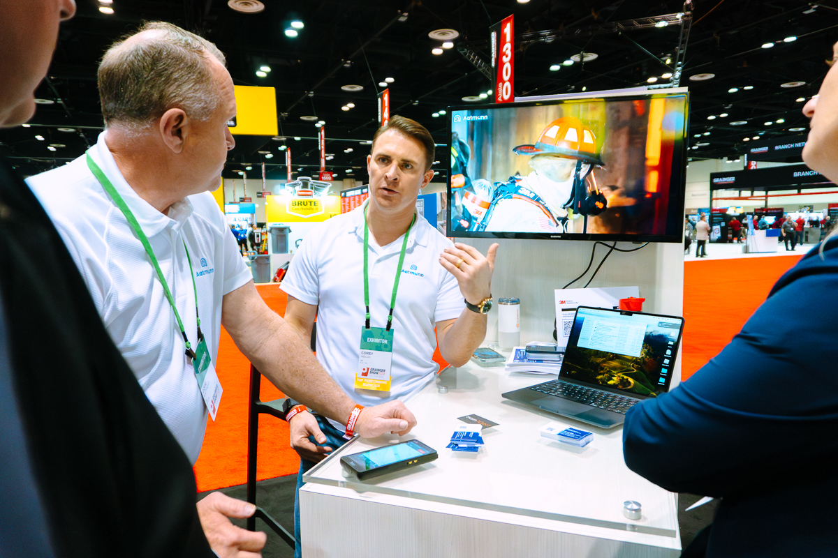 Exhibitor demonstrating technology at a trade show booth in the orange county convention center