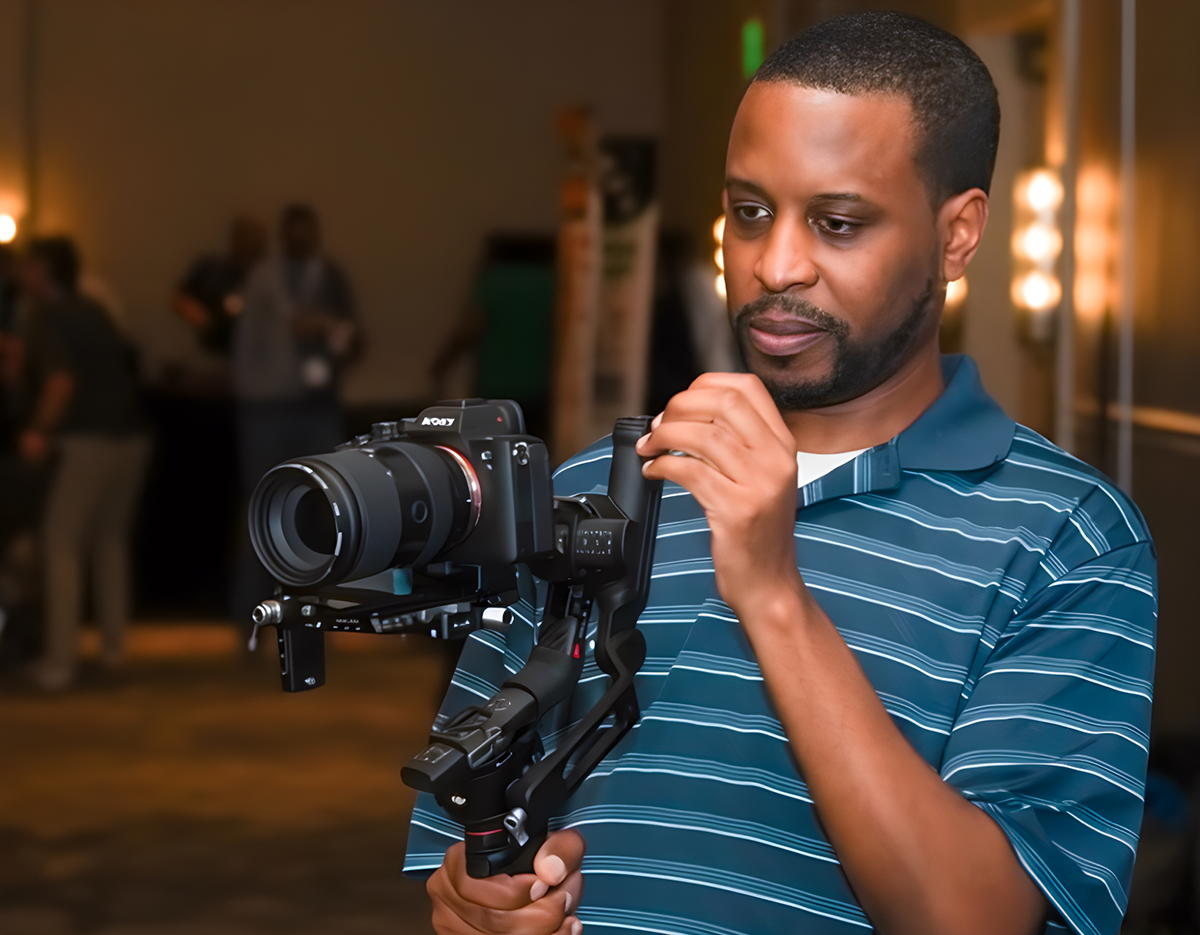 Orlando videographer operating a mirrorless camera on a handheld gimbal