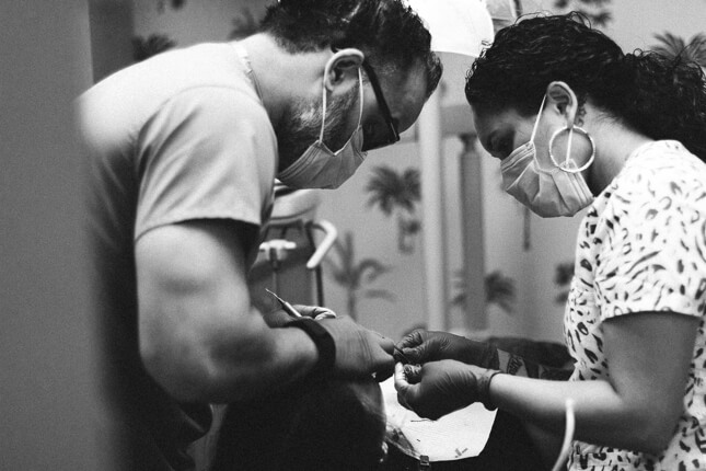 Dental team treating a patient at a dental office.
