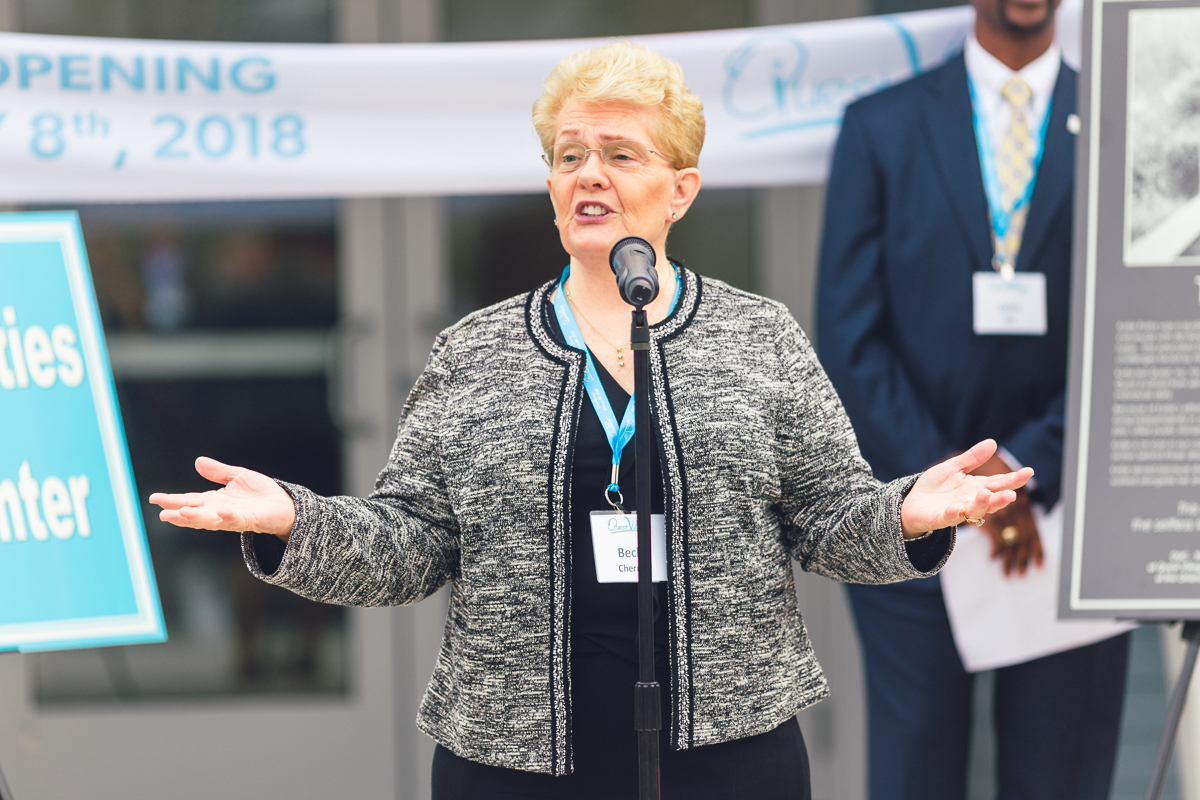 Woman speaking during the quest village grand opening ceremony