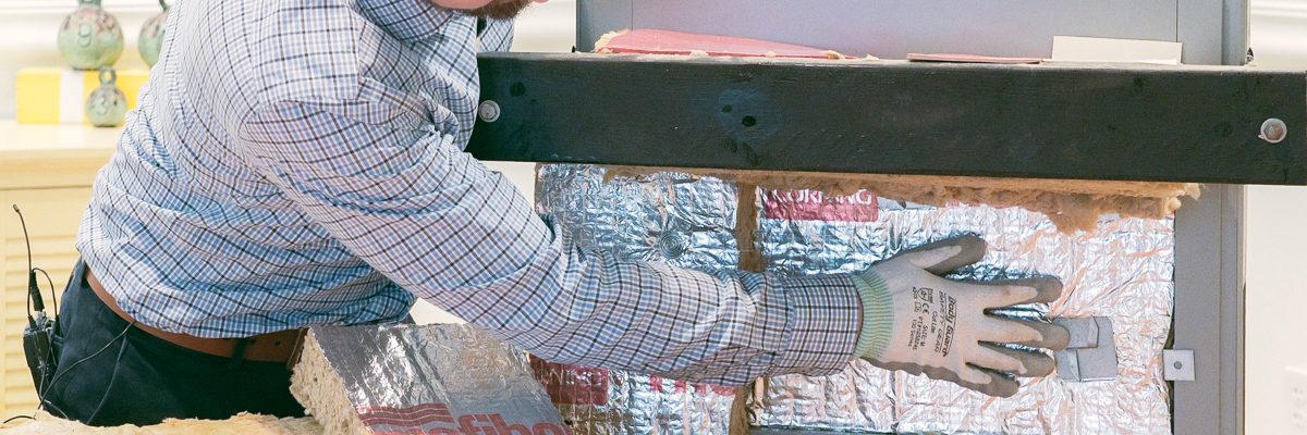 Instructor demonstrating insulation installation during a training video production.