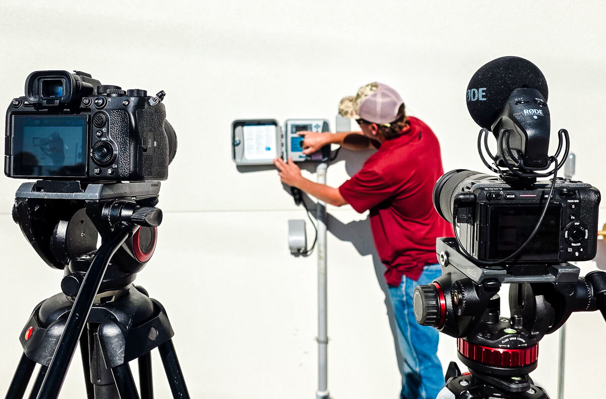 Two-camera setup recording a contractor demonstrating equipment during owner training at the mount dora public works facility.