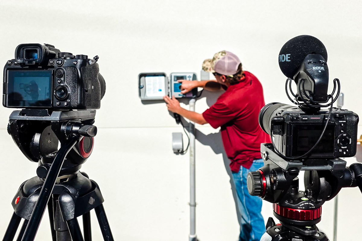 Two-camera setup recording a contractor demonstrating equipment during owner training at the Mount Dora Public Works Facility.