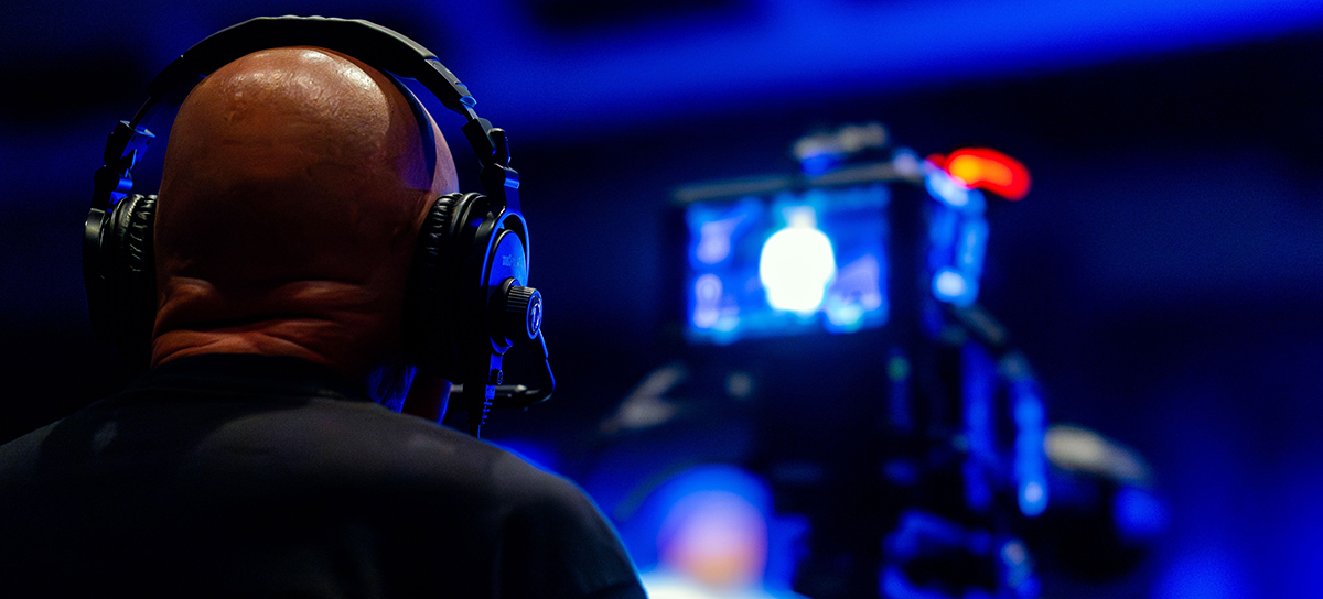 Camera operator wearing headphones during an orlando event video production.