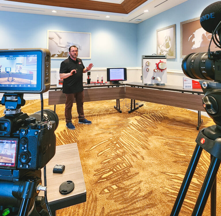 Multi-camera video production setup filming a presenter during a technical training demonstration at margaritaville resort orlando.