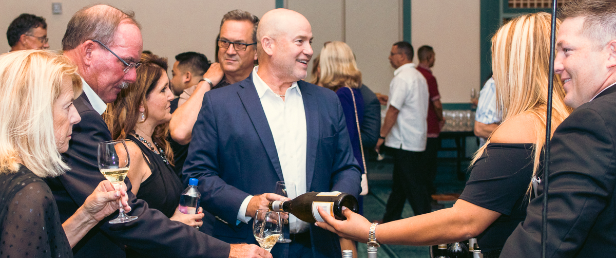 Guests participating in a wine tasting at loews royal pacific resort in orlando.