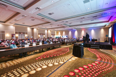 Wide view of attendees watching a keynote presentation at the 2025 AABC Annual Meeting at Omni Amelia Island Resort & Spa.